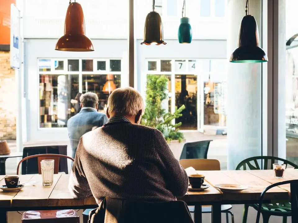 Cliente sentado en un café junto al escaparate